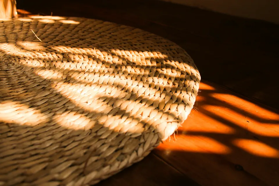 A woven straw basket catching dappled sunlight through leaves